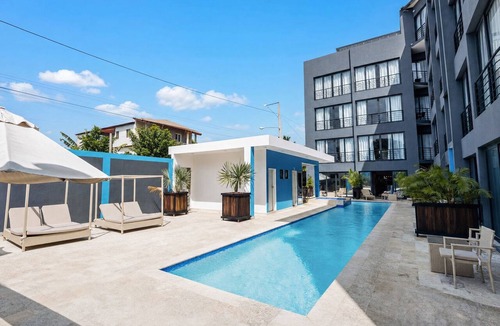 El Batey Apartment | 2BR at Rizz Suites Pool 24/7 GYM Walk to Beach 2 King Beds Sosua